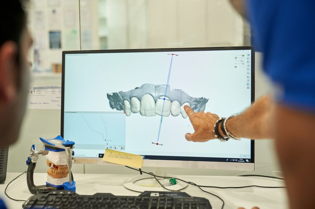 Prosthodontists at Princeton Prosthodontics in NJ reviewing a digital scan of a patient’s upper teeth, ensuring precise dental implant and crown placement.