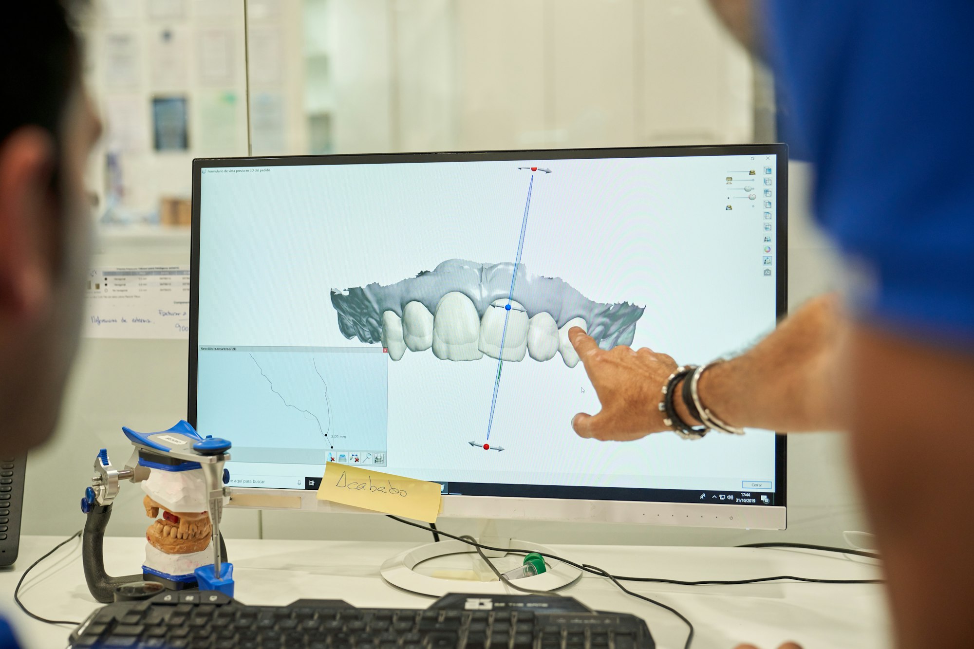 What Is a Prosthodontist Specialized - Unrecognizable Prosthodontists Examining Denture On Computer
